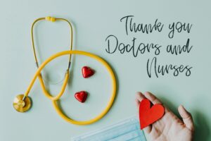 Yellow stethoscope composed with red hearts on white background with thank you doctors and nurses text and medical mask